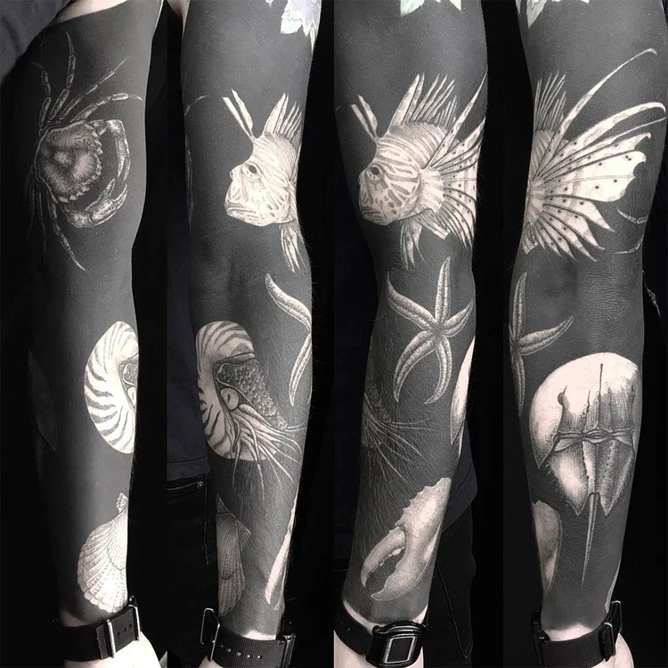 Negative space designs white ink tattoo on dark skin